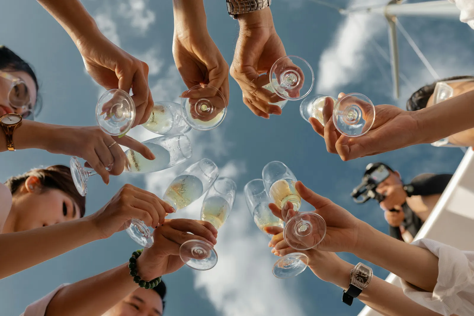 Guests raising champagne glasses at a yacht gathering