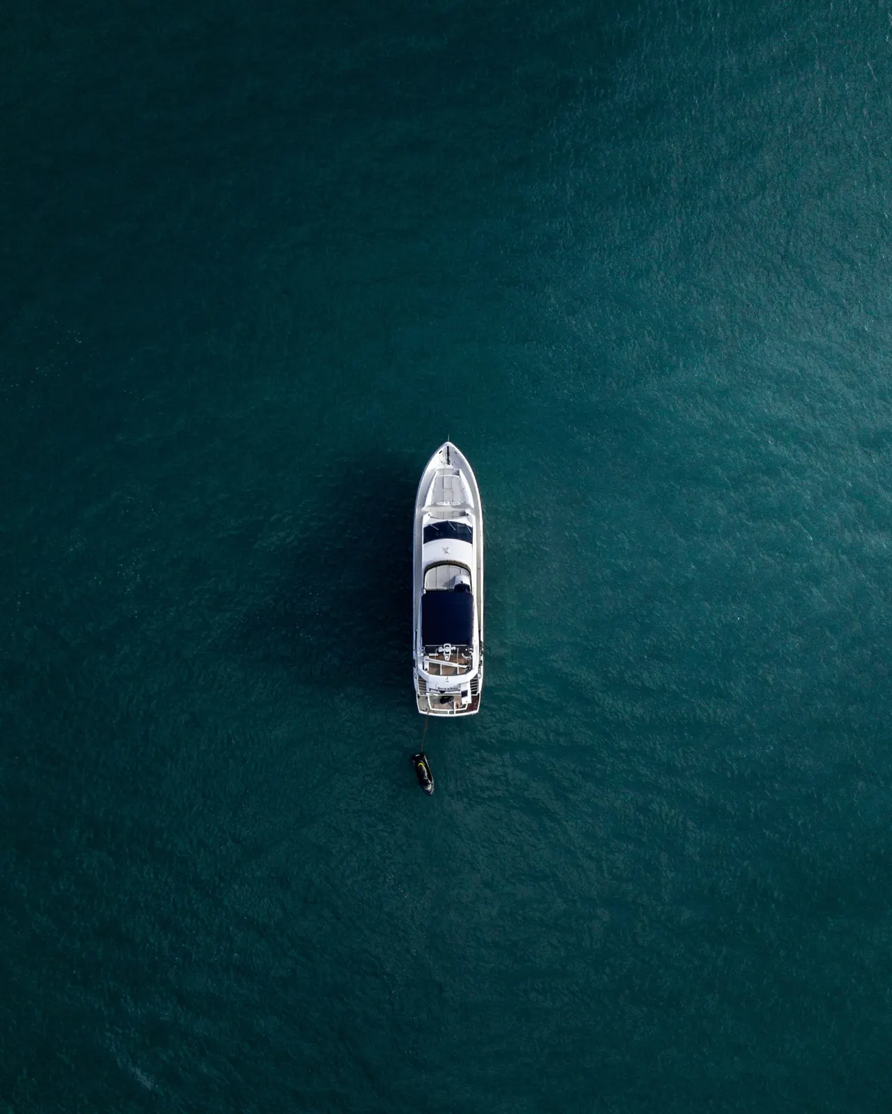 Aerial view of a superyacht on deep blue water