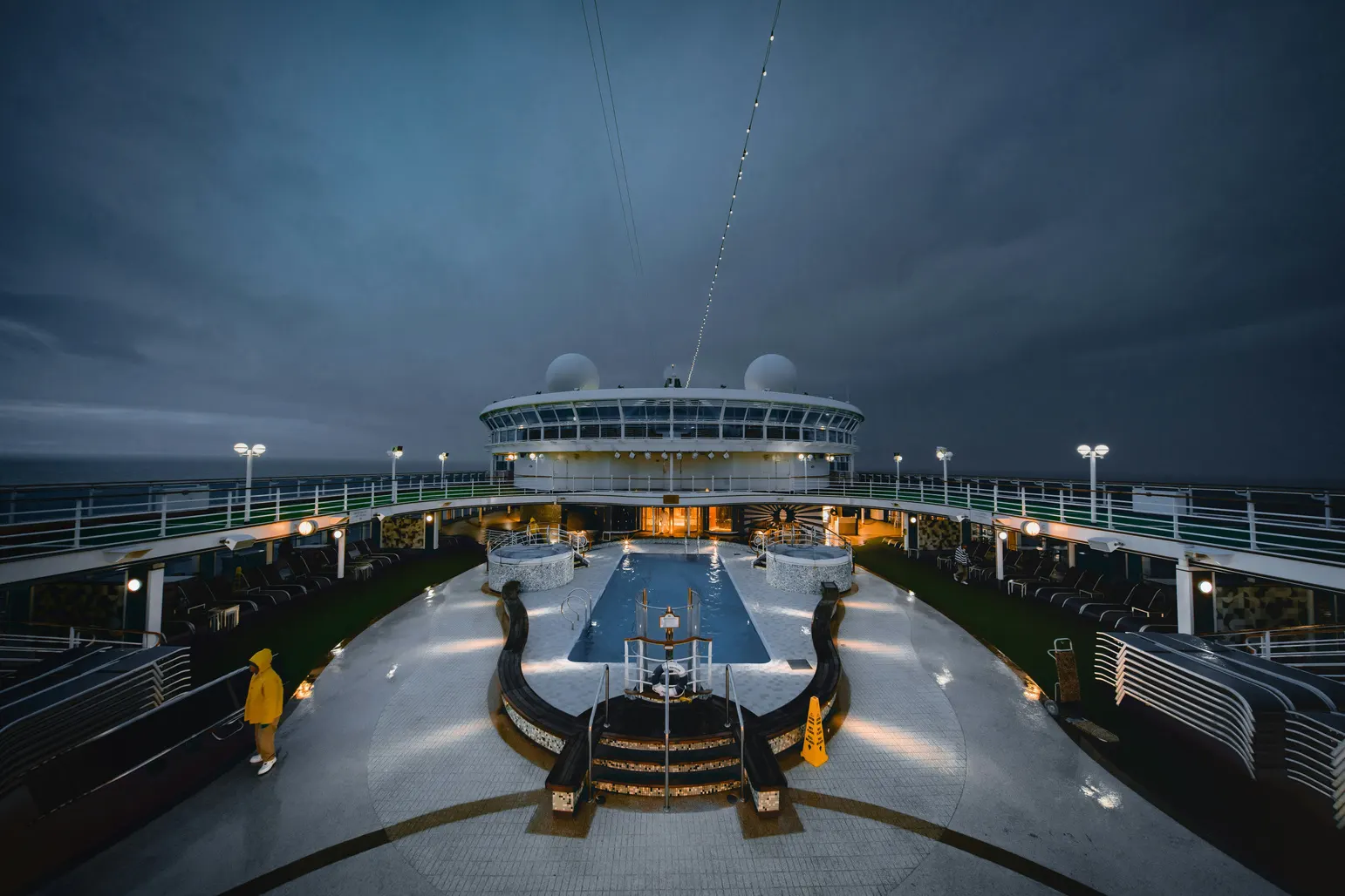 Superyacht aft deck lit up at dusk
